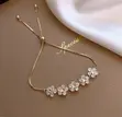 Adjustable Gold-Tone Bolo Bracelet with Floral Charms - 1