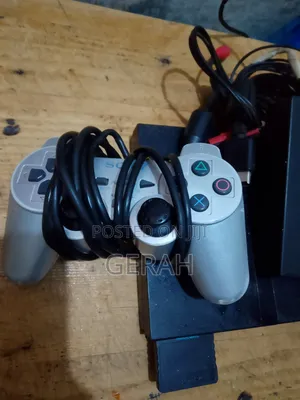 PS2 Slim Chipped Console with 2 Controllers & 8 Games