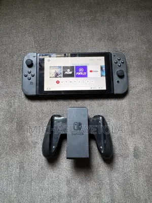 Nintendo Switch with FIFA 21 and Assassin's Creed
